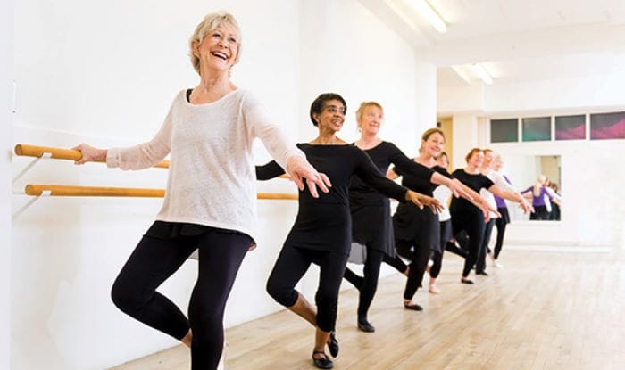 Dancers lined up in a row in a dance room