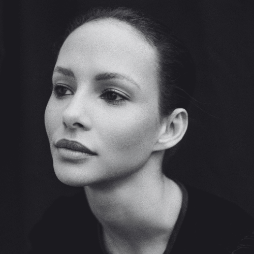 Black and white portrait of a woman with a calm thoughtful expression looking slightly to the left