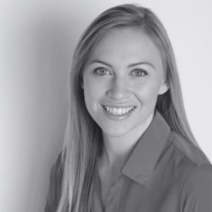 Portrait of a smiling woman with long blond hair wearing a collared shirt facing the camera